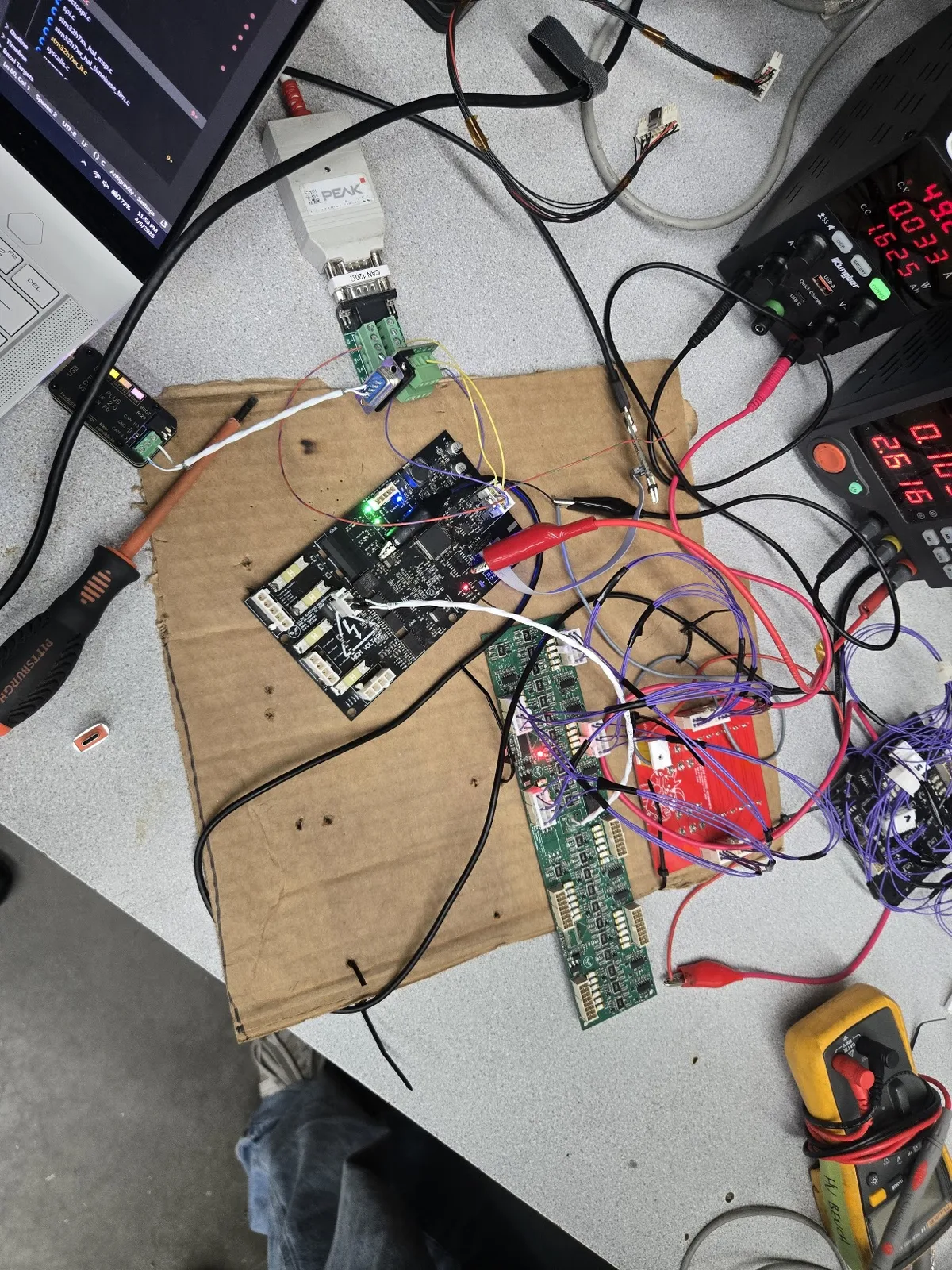 BMS bench setup with STM32H7 controller, cell monitors, CAN adapter, and power supplies